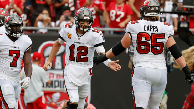 Tom Brady celebrates with teammates after a touchdown against the Falcons in Week 2